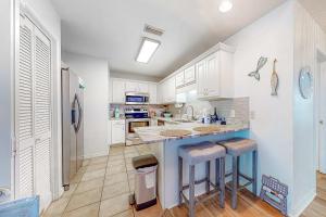 Sunlit two-story condo with pool walk one block to the beach