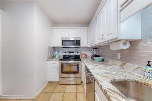 Sunlit two-story condo with pool walk one block to the beach