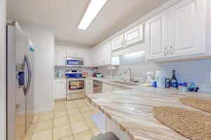 Sunlit two-story condo with pool walk one block to the beach