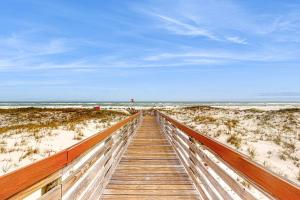 Gulf-front condo with beach access pools hot tub & sports courts