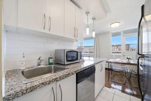 Stylish 2BR condo with 2 Balconies & Workspace