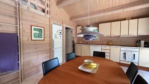 Traditional Log House Near Beach And Forest