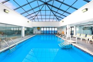 Captivating beachfront condo with balcony views pools gym & tennis court