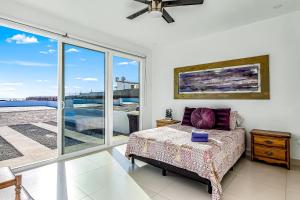 Dog-Friendly Oceanfront Villa with Rooftop Patio, Pool Access, & Kitchen