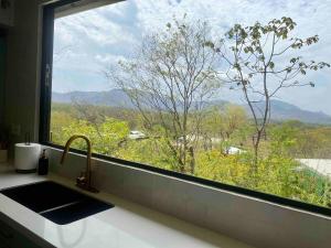 Private home in Playa Potrero near Flamingo with Infinity pool, 9 minute walk to beach, ocean, mountain, nature views, TV and AC in every room