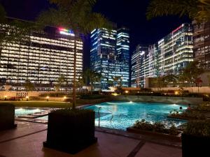 BRAND NEW unit in Uptown BGC with Balcony 55 Inch smart TV and 300Mbps WiFi, with Workspace, Beside Landers, near Uptown Mall and Mitsukoshi Mall