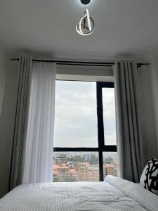 Cozy Modern 1BR with views on 10th floor at TSAVO APARTMENTS near TRM 15 mins to CBD