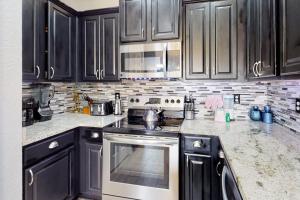 Dog-friendly home near beach with pool access two balconies wet bar & WD