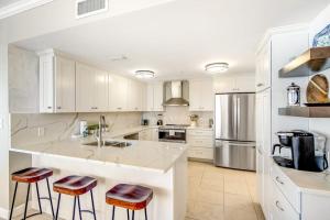 High-rise beachfront elegance with wraparound balcony pools & gym