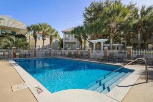3-story home with heated outdoor pool BBQ area balconies partial ocean views