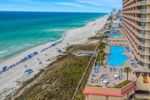 Tropical-themed 17th-floor condo with beachfront views pools & gym