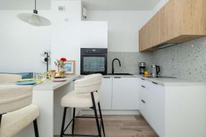 Sunny Apartment with a Balcony & Parking Near the Beach in Międzywodzie by Noclegi Renters