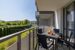 Stylish Apartment with a Balcony and Parking Close to Nature by Noclegi Renters