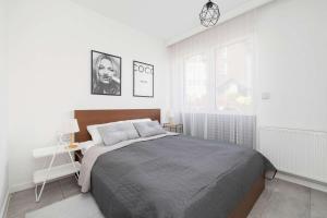 Stylish Apartment with a Balcony and Parking Close to Nature by Noclegi Renters