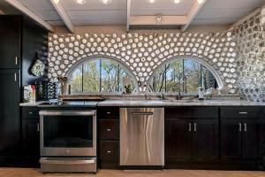 Artistic Earth House with Vibrant Glass Bottle Architecture Near Saguaro National Park in Tucson, Arizona