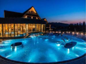 A large mountain-style house with a spa area