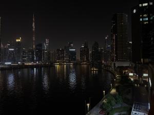1BR Canal-Front Balcony with Burj Khalifa View - Live Luxe Dubai