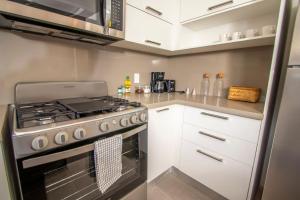 Stylish New 2-Bedroom Apartment with Pools & Gym