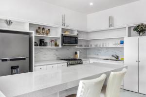 Dog-friendly retreat with ocean-view rooftop deck, pool, hot tub, & kitchen