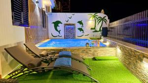 Villas Puerto Rico in front of the shopping center with private heated saltwater pool with jacuzzi function & arcade games