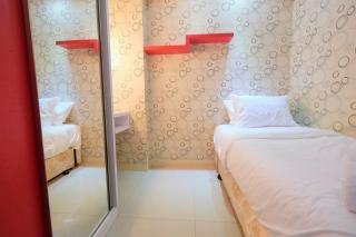Homey and Relaxing 2BR Green Pramuka City Apartment By Travelio - 1