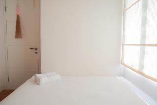 Pool View 2BR with Sofa Bed Bassura City Apartment By Travelio - 1