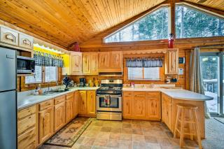 Cozy Manistique Cabin with Deck, Grill and Fire Pit! - 1