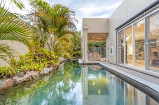 Luxury resort style villa pool by Custom Bnb Hosting - Pelican Waters - 0