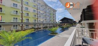 JC SpaceRentals 127B Amani Grand Resort Residences, balcony pool view, Ground floor, 5 mins frm airport, free wifi, Netflix - Pusok - 9