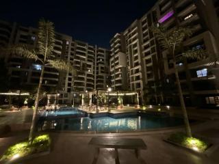 Luxurious 2-Bedroom Apartment in Primera Compound with Scenic Pool Views - Cairo - 9