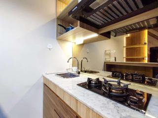 Fancy and Nice 1BR with Extra Room at Amartha View Apartment By Travelio - 2