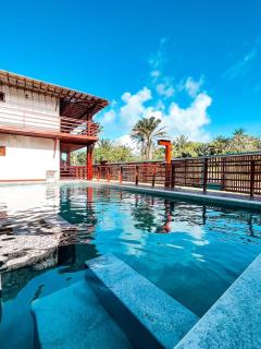 A2 uma suite, cozinha, sala, frente pisc · Alicena Mutá Cond. Fechado - apto A2 - 8