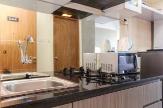 Homey and Tidy Studio at The Oasis Apartment By Travelio - Bekasi - 7