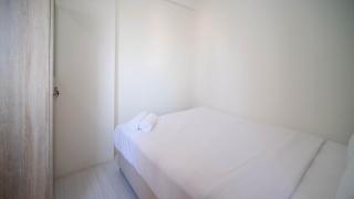 Cozy Living and Tidy 2BR at Puncak Dharmahusada Apartment By Travelio - 9