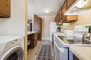 Riverside Condo, with a Pool & Hot Tub - Steps to Town - 1