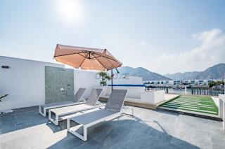 Blue Marble Beach 4BR Villa with Assistants Room, Private Pool, Access to Floating Pier, and Sea and Mountain Views, Al Dana Island, Fujairah by Deluxe Holiday Homes - 1