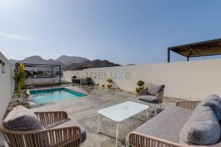 Blue Marble Beach 4BR Villa with Assistants Room, Private Pool, Access to Floating Pier, and Sea and Mountain Views, Al Dana Island, Fujairah by Deluxe Holiday Homes - 0