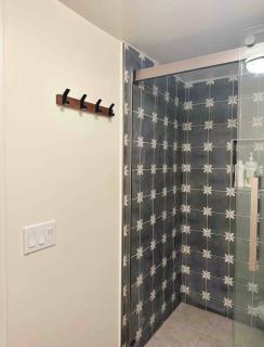 A small room in the backyard with a full bed - 5