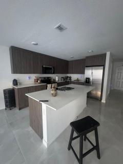 Modern room with kitchen and backyard access - 8