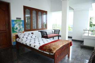 A CLASS King bedroom with balcony view, extra bed, and a spacious bathroom with changing area - 6