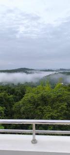 A CLASS King bedroom with balcony view, extra bed, and a spacious bathroom with changing area - 3