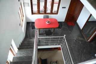 A CLASS King bedroom with balcony view, extra bed, and a spacious bathroom with changing area - 2