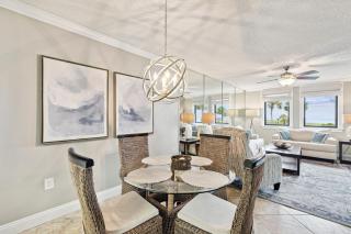 Bright ocean-view condo with community pool and direct beach walkway - 1