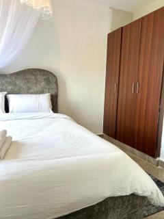 Nesty 2BR Ensuite - Elevator, Secure Parking & WiFi Near United Mall and Mega City - 1
