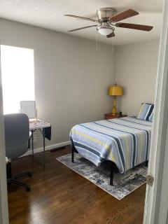 bedroom with twin mattress and desk - 3