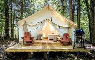Comfortable Tent Retreat with Lounge Chairs, Fire Pit, Grill & Thoughtful Amenities in Broadalbin, New York - 0