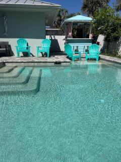 Enjoy a relaxing coastal getaway at this and comfortable 4-bedroom home in New Smyrna Beach, located in a great area just minutes from the ocean. Perfect for families, groups, and vacationers, the property features great WiFi, a private swimming poo - 8