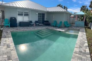 Enjoy a relaxing coastal getaway at this and comfortable 4-bedroom home in New Smyrna Beach, located in a great area just minutes from the ocean. Perfect for families, groups, and vacationers, the property features great WiFi, a private swimming poo - 5