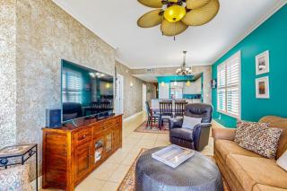 Beachfront condo with beach chairs an umbrella and a pool - 8