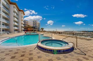 Beachfront condo with beach chairs an umbrella and a pool - 7